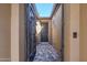 View of the front door through a gated entry and brick-paved walkway at 830 E Garden Basket Dr, Queen Creek, AZ 85140