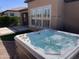 Outdoor hot tub with clear water, set against a backdrop of desert landscaping and a stucco home at 830 E Garden Basket Dr, Queen Creek, AZ 85140