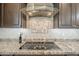 Close-up of the kitchen's glass cooktop and modern ventilation hood at 830 E Garden Basket Dr, Queen Creek, AZ 85140