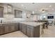 Spacious kitchen featuring granite countertops, stainless steel appliances, and tile backsplash at 830 E Garden Basket Dr, Queen Creek, AZ 85140