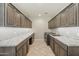 Spacious laundry room with generous counter space, abundant cabinets, and modern appliances at 830 E Garden Basket Dr, Queen Creek, AZ 85140