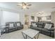 Comfortable living room featuring neutral tones, tile flooring, and ample natural light at 830 E Garden Basket Dr, Queen Creek, AZ 85140