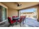 Relaxing covered outdoor patio area with ceiling fan and outdoor seating for enjoying the weather at 830 E Garden Basket Dr, Queen Creek, AZ 85140