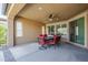 Relaxing covered patio with outdoor dining set, ceiling fan, and view of the yard at 830 E Garden Basket Dr, Queen Creek, AZ 85140