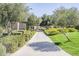 Picturesque walking path lined with trees and hedges, creating a serene environment for residents at 830 E Garden Basket Dr, Queen Creek, AZ 85140