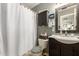 Well-lit bathroom with sink, mirror, toilet and tub with shower, plus storage cabinet at 8520 E Laguna Azul Ave, Mesa, AZ 85209