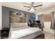 This bedroom has gray walls, a ceiling fan, and a king-size bed with decorative pillows and bedside tables at 8520 E Laguna Azul Ave, Mesa, AZ 85209