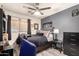 Well-lit bedroom featuring neutral walls, ceiling fan, and dark furniture accents, creating a comfortable space at 8520 E Laguna Azul Ave, Mesa, AZ 85209