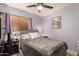 Cozy bedroom with a large bed, soft lighting, and wood-look floors offering a relaxing retreat at 8520 E Laguna Azul Ave, Mesa, AZ 85209