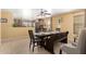 Cozy dining area with a wooden table and seating for six, plus a ceiling fan at 8520 E Laguna Azul Ave, Mesa, AZ 85209