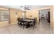 Bright dining room with a long table and seating for six, with a ceiling fan overhead at 8520 E Laguna Azul Ave, Mesa, AZ 85209