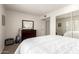 Cozy bedroom featuring a queen bed, carpet floors, a dresser, and a view of the closet at 9710 N 94Th Pl # 216, Scottsdale, AZ 85258