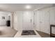 Welcoming entryway featuring neutral tile, a large white door, and ample natural light at 9710 N 94Th Pl # 216, Scottsdale, AZ 85258