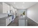 Modern kitchen featuring granite countertops, stainless steel appliances, and gray laminate floors at 10329 N 115Th Ave, Youngtown, AZ 85363