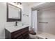 This bathroom includes a vanity sink and a shower with accessibility grab bars at 10859 W Coggins Dr, Sun City, AZ 85351