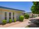 A serene exterior view showcasing desert landscaping and a well-maintained community at 10859 W Coggins Dr, Sun City, AZ 85351
