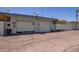 Garage exterior featuring multiple doors, exterior lighting and driveway at 10859 W Coggins Dr, Sun City, AZ 85351