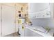 Functional laundry area features a stacked washer/dryer and water heater for convenience at 10859 W Coggins Dr, Sun City, AZ 85351