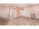 Open living room with wood-look floors, bright lighting, and neutral paint at 10859 W Coggins Dr, Sun City, AZ 85351