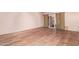 Spacious living room with wood-look floors and a sliding door for natural light at 10859 W Coggins Dr, Sun City, AZ 85351