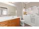 Accessible bathroom featuring a seated walk-in bathtub and vanity at 10918 E Oro Ave, Mesa, AZ 85212