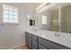 Clean bathroom features double sinks, a large mirror, and glass block windows at 10918 E Oro Ave, Mesa, AZ 85212
