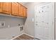 Functional laundry room features overhead storage and exterior access at 10918 E Oro Ave, Mesa, AZ 85212