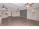 Open-concept living room features wood floors, ceiling fans and natural light at 10918 E Oro Ave, Mesa, AZ 85212