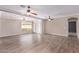 Bright, open living room with hardwood floors, ceiling fans and natural light from an adjacent window at 10918 E Oro Ave, Mesa, AZ 85212