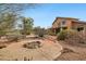 Spacious backyard with desert landscaping and a fire pit providing a relaxing outdoor living space at 11263 S Oakwood Dr, Goodyear, AZ 85338