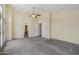 Bright primary bedroom featuring plush carpet, an ensuite, ceiling fan, and balcony access at 11263 S Oakwood Dr, Goodyear, AZ 85338