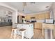 Open kitchen featuring stainless appliances, a central island, and light wood cabinets at 11341 W Barbara Ave, Peoria, AZ 85345