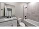 Well-lit bathroom featuring a shower-tub combination and vanity with granite countertop and dark hardware at 11522 W Deanne Dr, Youngtown, AZ 85363