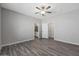A spacious bedroom with a ceiling fan and doorway that leads into an attached bathroom and walk-in closet at 11522 W Deanne Dr, Youngtown, AZ 85363