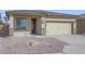 Charming single-story home featuring a two-car garage, stone accents, and low-maintenance desert landscaping at 11522 W Deanne Dr, Youngtown, AZ 85363