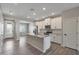 Bright kitchen with stainless steel appliances, a large island, and stylish white cabinetry at 11522 W Deanne Dr, Youngtown, AZ 85363