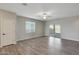Neutral living room with a ceiling fan and a sliding door that leads to the outside at 11522 W Deanne Dr, Youngtown, AZ 85363