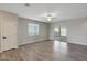 Spacious living room with wood-look flooring, ceiling fan, and sliding door access to the outdoors at 11522 W Deanne Dr, Youngtown, AZ 85363