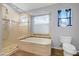 Bathroom featuring a soaking tub, separate shower, and a window at 1225 E Sea Gull Dr, Gilbert, AZ 85234