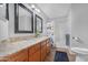 Bright bathroom features a double vanity, granite countertop, framed mirrors and shower at 1225 E Sea Gull Dr, Gilbert, AZ 85234