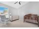 Bedroom featuring a vaulted ceiling, crib, neutral colors, and a rocking chair at 1225 E Sea Gull Dr, Gilbert, AZ 85234