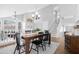 Dining room with hardwood floors, a dark wood table, and a view into the living room and stairway at 1225 E Sea Gull Dr, Gilbert, AZ 85234
