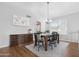 Dining room with hardwood floors, a dark wood table, and a view of the backyard windows at 1225 E Sea Gull Dr, Gilbert, AZ 85234