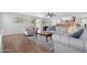 Open-concept living room with a ceiling fan, wood flooring, and bright natural light at 1225 E Sea Gull Dr, Gilbert, AZ 85234