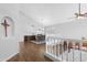 Bright living room with hardwood floors, high ceilings, white railing, and views into the dining area at 1225 E Sea Gull Dr, Gilbert, AZ 85234