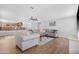 Open living room with wood floors, neutral paint, ceiling fan, and views to the kitchen and breakfast nook at 1225 E Sea Gull Dr, Gilbert, AZ 85234