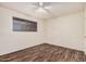 Bright bedroom with hardwood floors, a ceiling fan, and a window at 1238 E Barcelona Ave, Casa Grande, AZ 85122