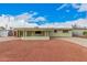 Charming single-story home featuring a large, gravel-covered front yard and an inviting covered porch at 1238 E Barcelona Ave, Casa Grande, AZ 85122