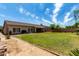 Large backyard with mature trees and lush green lawn, ideal for outdoor activities and relaxation at 13516 W Windsor Blvd, Litchfield Park, AZ 85340