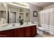 Bathroom featuring double sinks, updated fixtures and granite countertop at 13516 W Windsor Blvd, Litchfield Park, AZ 85340